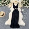 A Two-piece Knitted Vest With A Slimming, Body-hugging, Slit Skirt